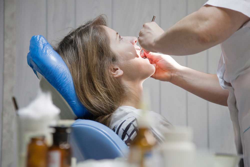 Patient undergoing wisdom teeth removal procedure at professional dental clinic