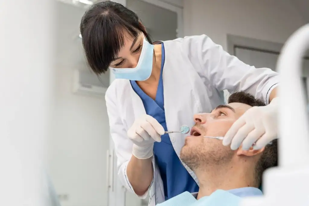 Patient getting a tooth implant checkup from a dentist at a modern dental clinic