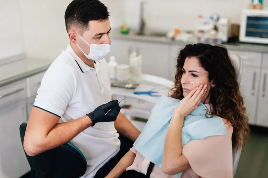 Woman with toothache waiting for delayed tooth implant treatment at dentist clinic