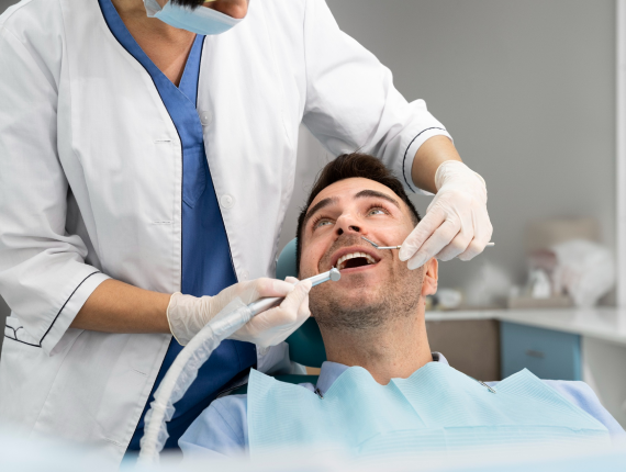 Dentist examining a smiling patient during a routine dental check-up at Affordable Dentist Melbourne clinic